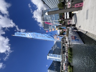 Clipper Round the World race yachts moored with masts and pennants against a city skyline
